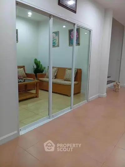 Cozy living room with glass sliding doors and stylish wicker furniture