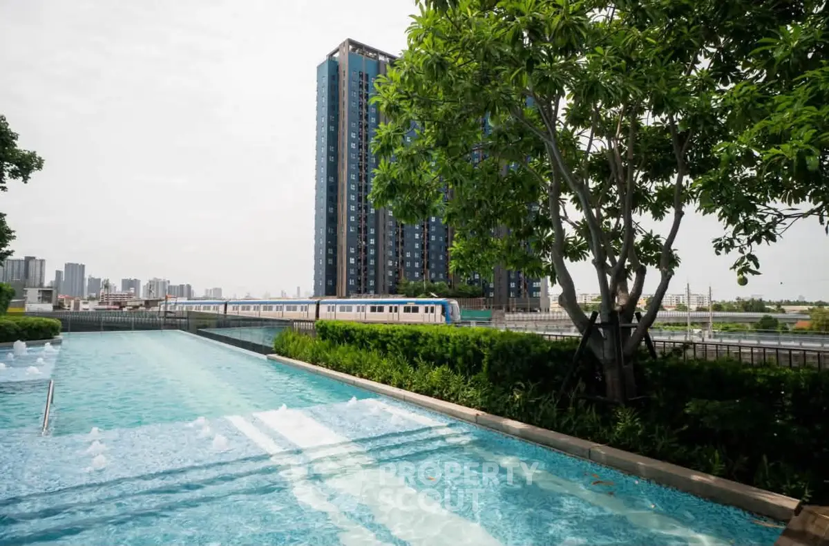 Luxurious condominium with pool and city skyline view, perfect for urban living.