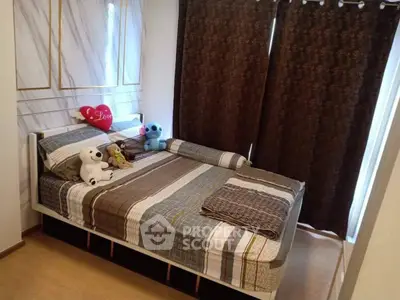 Cozy bedroom with stylish decor and plush toys on bed