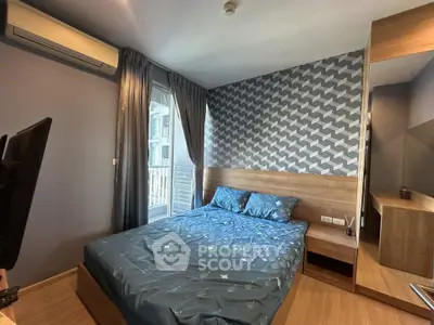 Modern bedroom with stylish geometric wallpaper and cozy furnishings in a contemporary apartment.