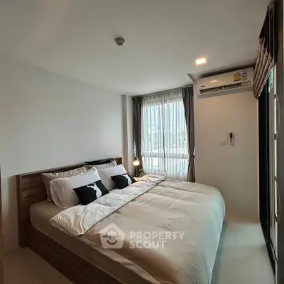 Modern bedroom with large bed and natural light in stylish apartment