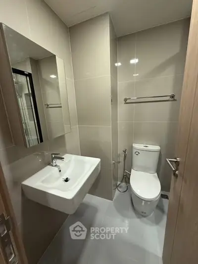 Modern bathroom with sleek fixtures and neutral tiles