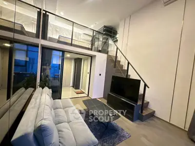 Modern duplex living room with stylish staircase and cozy seating area