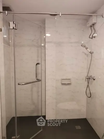 Modern bathroom with glass shower enclosure and sleek fixtures