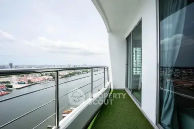Stunning high-rise balcony with panoramic river view and glass doors.