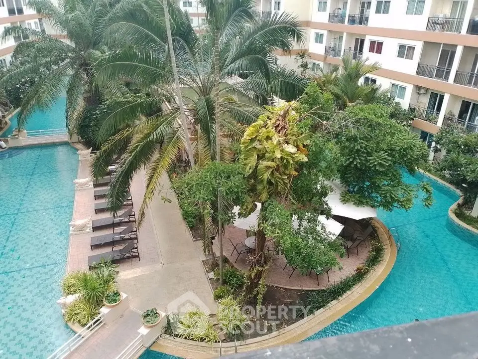 Luxurious apartment complex with stunning pool and lush greenery