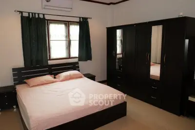 Spacious bedroom with modern furniture and natural light