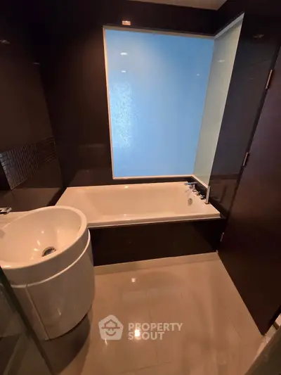 Modern bathroom with sleek bathtub and stylish sink in a contemporary apartment.