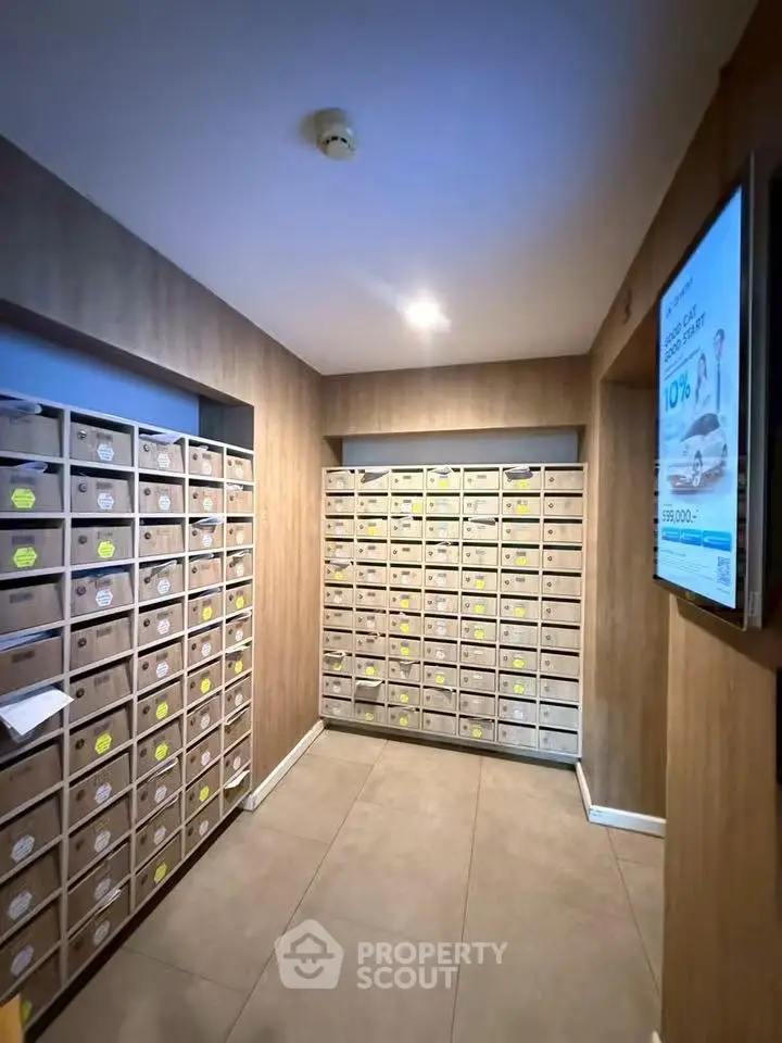 Modern apartment building mailroom with organized mailboxes and sleek design.