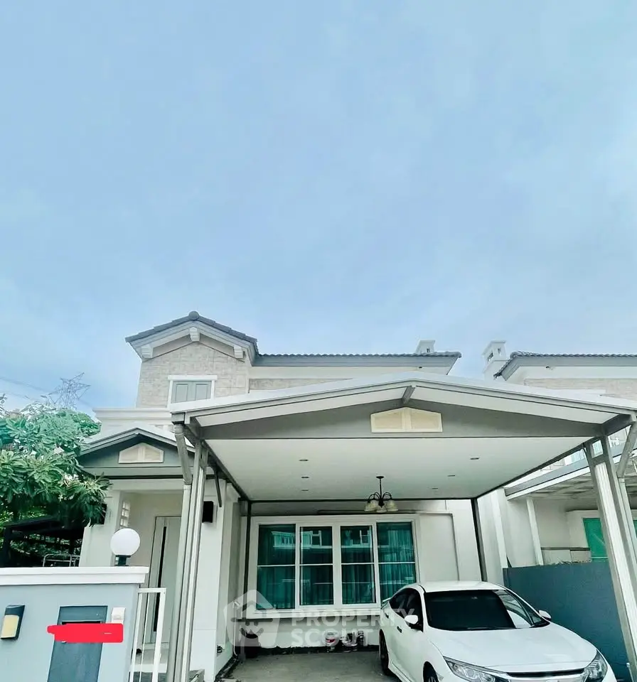 Charming two-story house with carport and modern exterior design, perfect for family living.