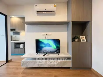 Modern living room with TV, air conditioning, and open kitchen layout
