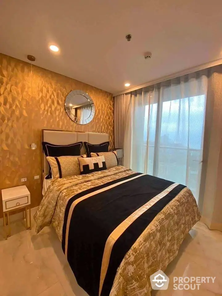 Luxurious bedroom with elegant decor and large window offering natural light.