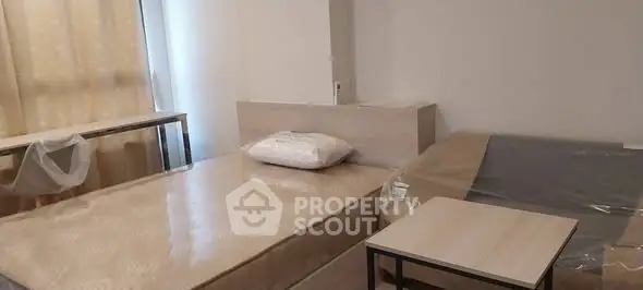 Spacious bedroom with twin beds and modern decor in a cozy apartment.