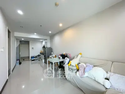 Spacious living room with modern decor and plush seating