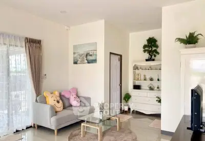 Charming living room with cozy sofa, glass coffee table, and elegant decor.