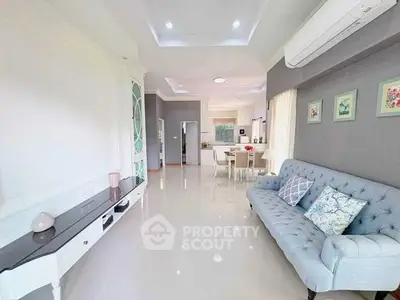 Spacious living room with elegant decor and open layout, featuring a stylish sofa and modern furnishings.