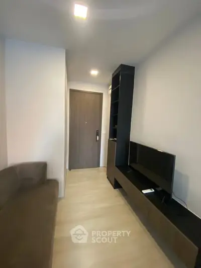 Modern living room with sleek furniture and wall-mounted TV