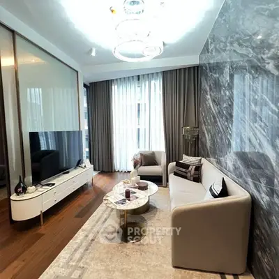 Luxurious modern living room with marble accent wall and elegant furnishings.