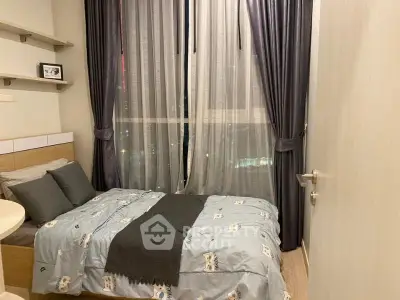 Cozy bedroom with large window and elegant curtains in modern apartment