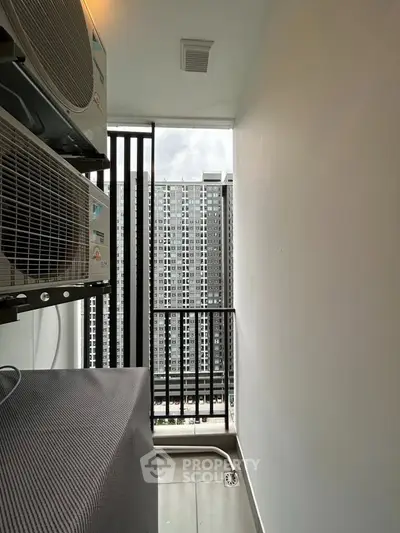 Modern apartment balcony with city view and air conditioning units, perfect for urban living.