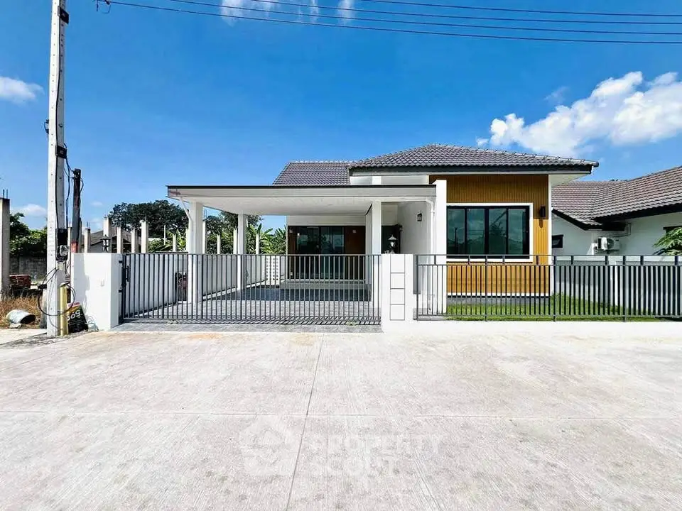 Modern single-story house with spacious driveway and sleek design