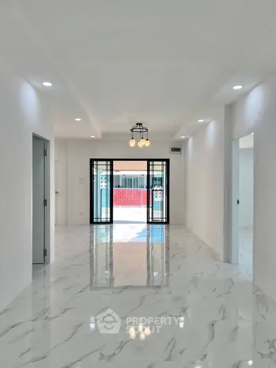 Spacious modern living room with marble flooring and elegant lighting