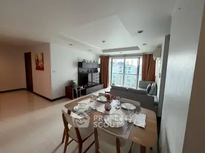 Spacious living room with dining area and city view, perfect for modern living.