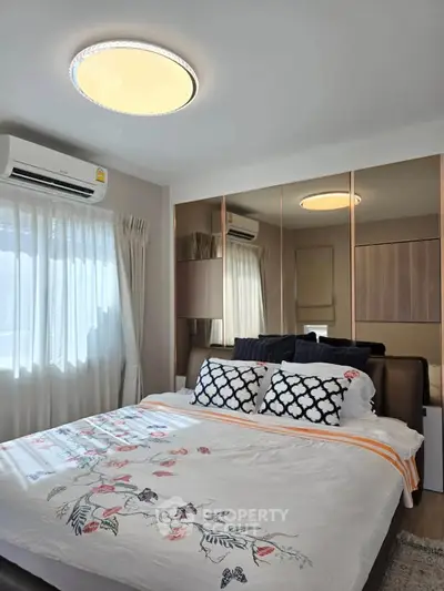 Cozy bedroom with elegant decor and ample natural light