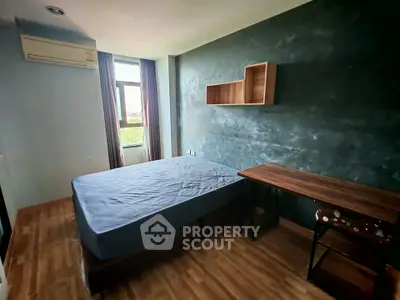 Modern bedroom with stylish wooden flooring and natural light