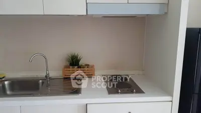 Modern compact kitchen with electric stove and sleek cabinetry