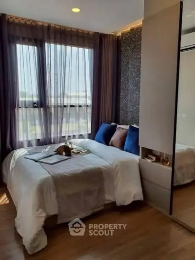 Cozy modern bedroom with large window and stylish decor