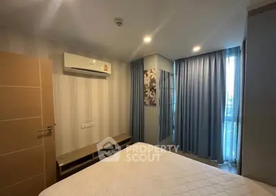 Modern bedroom with air conditioning and stylish decor in a high-rise apartment.