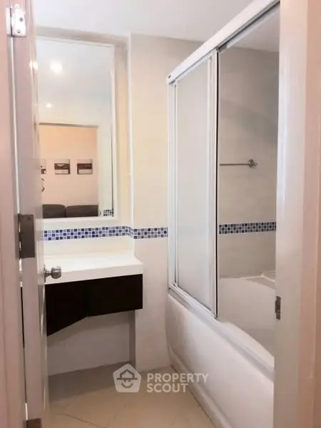 Modern bathroom with sleek design and bathtub in a stylish apartment.