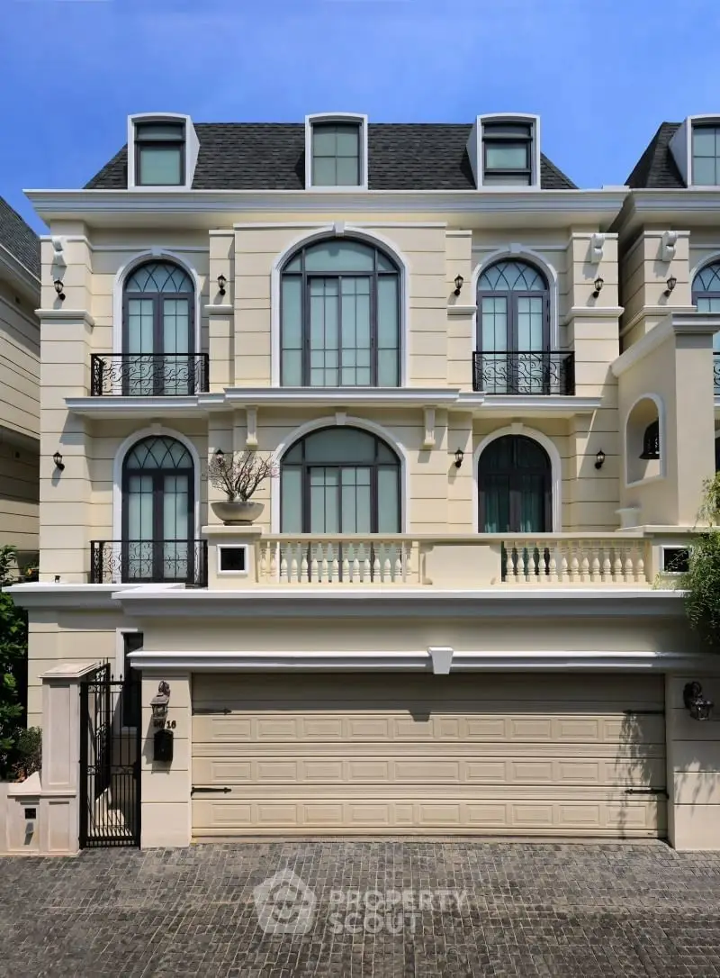 Elegant three-story residential building with classic architecture and large windows.