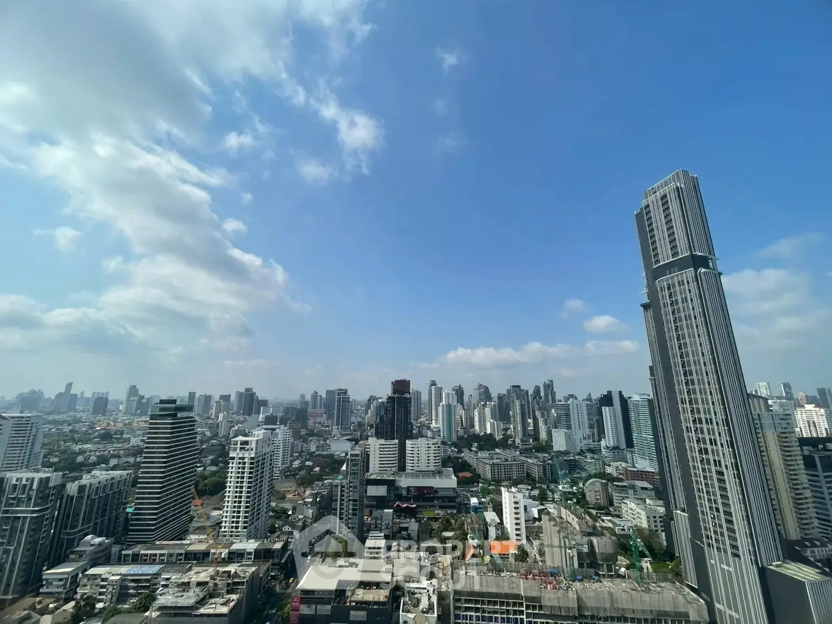 Stunning cityscape view from a high-rise building showcasing urban skyline and modern architecture.
