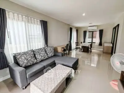 Spacious living room with modern furniture and large windows for natural light.