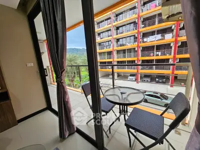 Modern balcony with mountain view and cozy seating area in urban setting