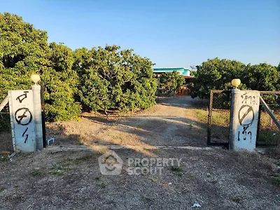 Charming rural property with gated entrance and lush greenery, perfect for serene living.
