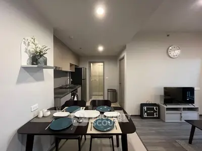Modern dining and living area with sleek kitchen and stylish decor