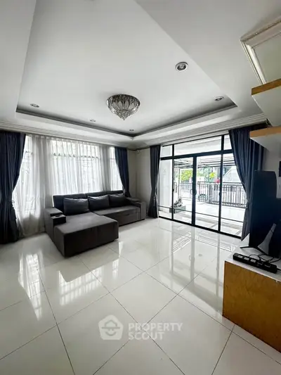 Spacious modern living room with large windows and elegant decor