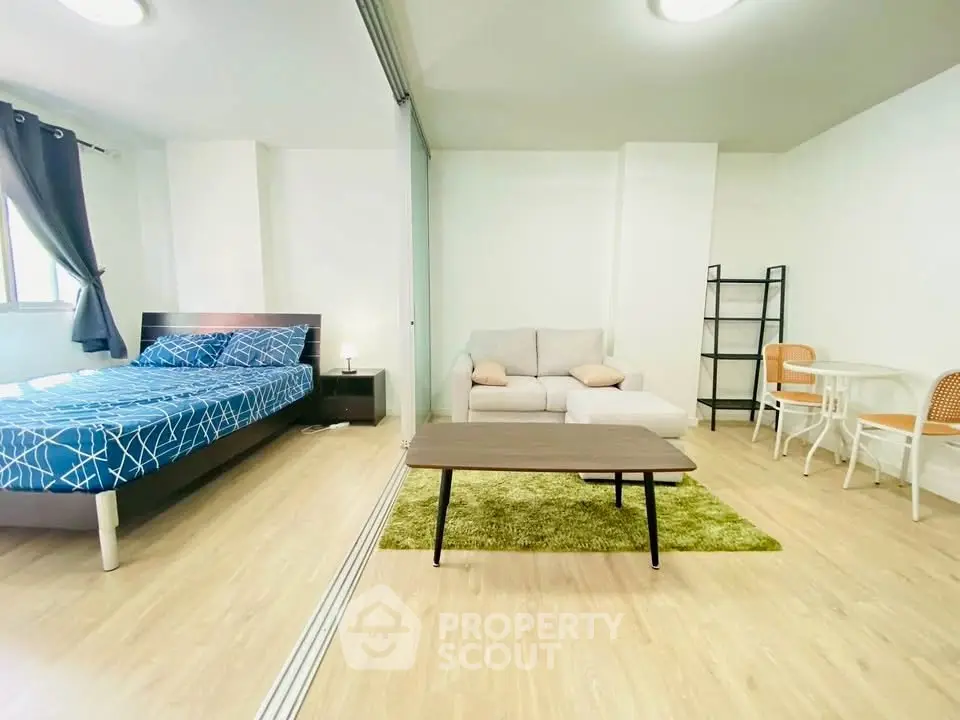 Modern studio apartment with cozy living area and stylish bedroom