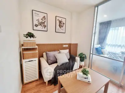 Modern living room with cozy sofa, stylish decor, and natural light from large windows.