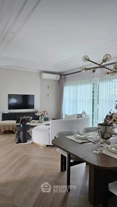 Elegant living room with modern decor and large windows for natural light