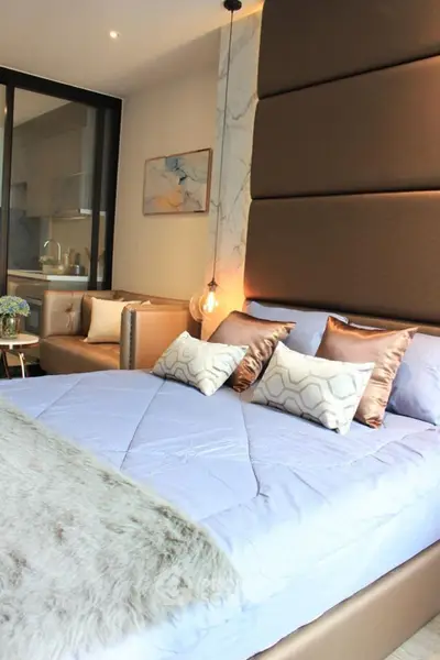 Luxurious bedroom with modern decor and plush bedding in a stylish apartment.