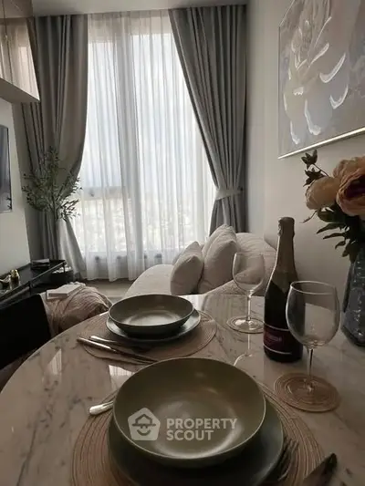 Elegant living room with dining setup and large window view