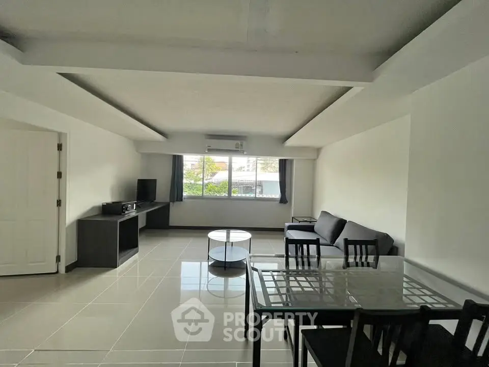 Spacious living room with modern furniture and large windows for natural light.