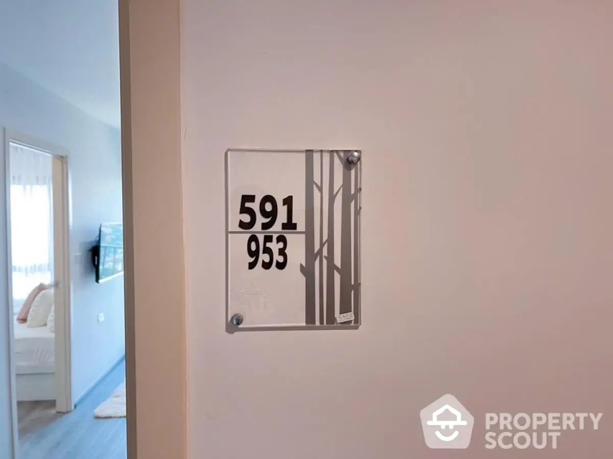 Modern apartment entrance with stylish room number plaque