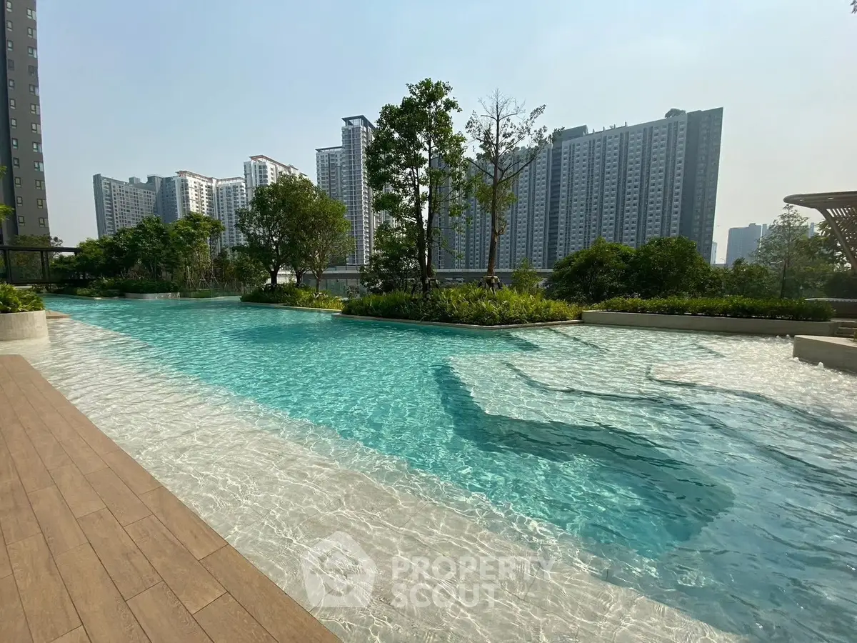 Luxurious residential pool with stunning cityscape view and lush greenery.