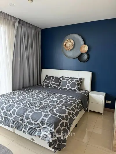 Modern bedroom with stylish decor and natural light, featuring a comfortable bed and elegant wall art.