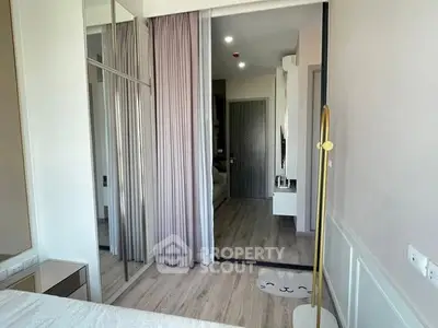 Modern bedroom with mirrored closet and stylish decor